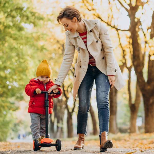 mother-with-little-son-scooter-autumnal-park