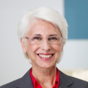 Person with curly hair smiling