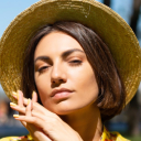 Person with long straight brown hair and closed eyes