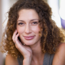 Smiling person with short white hair